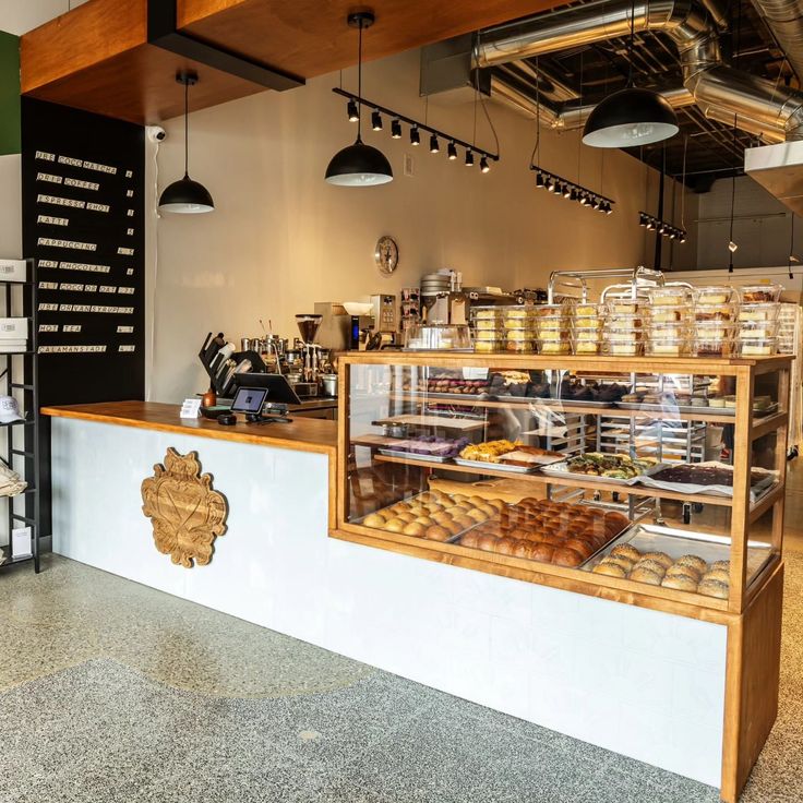 the inside of a bakery with lots of pastries on display