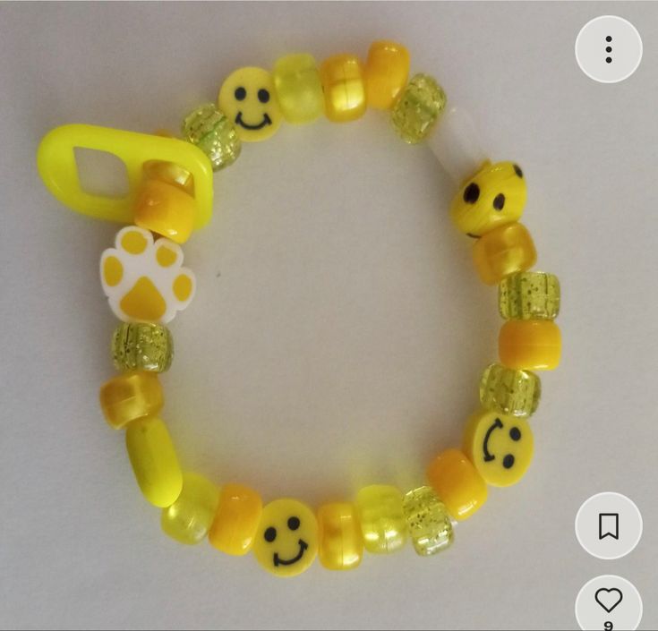 a bracelet with yellow beads and smiley faces