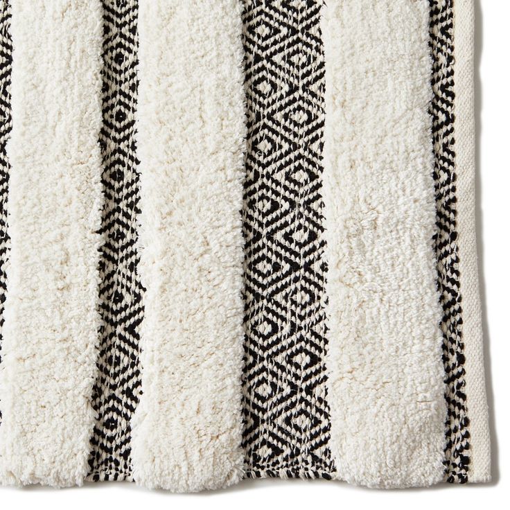 a black and white striped rug on a white background