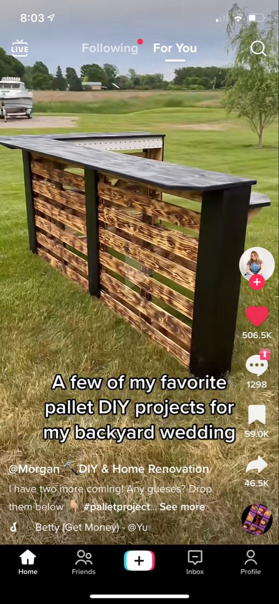 an outdoor bar made out of pallet wood with the words backyard wedding on it