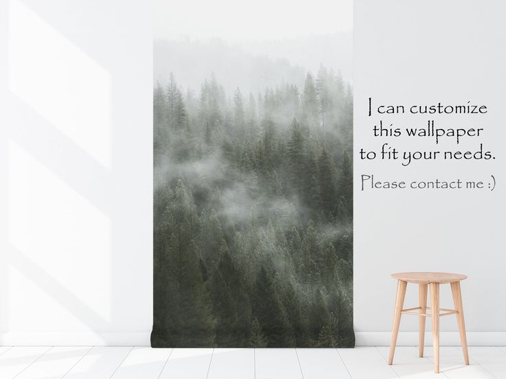 a wall hanging with a quote on it next to a stool in front of a forest