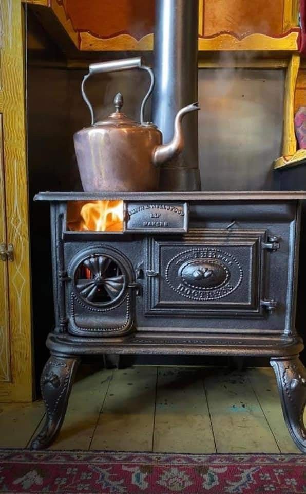 an old fashioned stove with a kettle on top