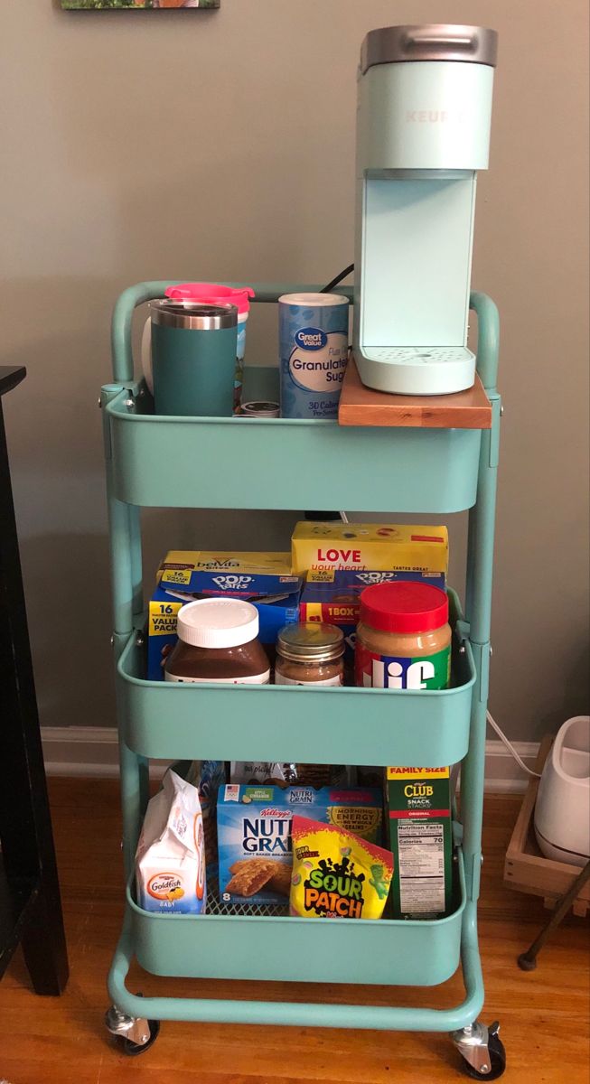 a blue cart with food and drinks on it