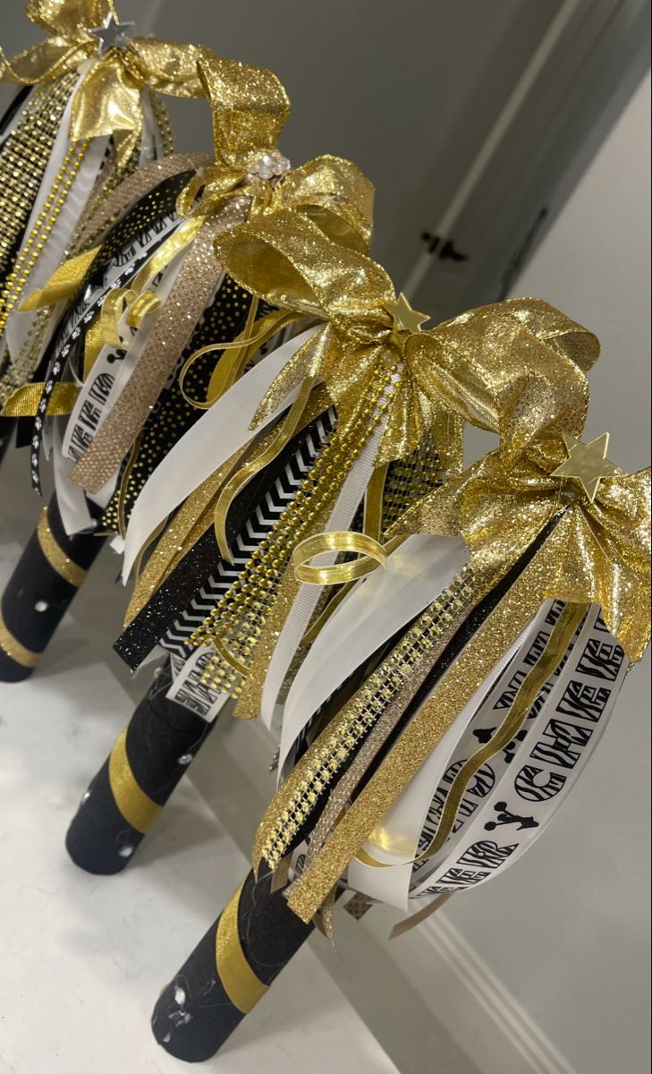 Black and gold cheer spirit sticks Cheer Spirit Stick Ideas, Cheerleader Spirit Sticks, Diy Cheer Spirit Sticks, School Spirit Stick, Spirt Stick Ideas, Spirit Stick Ideas Diy Cheer, Cheer Sticks Spirit Diy, How To Make A Spirit Stick Cheer, Cheerleading Spirit Stick Ideas Diy