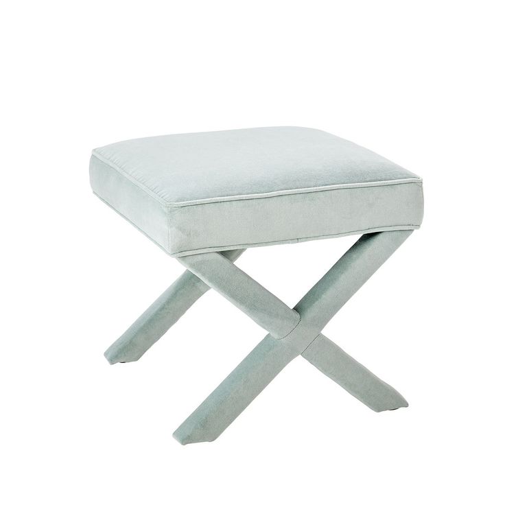 a small stool with a white cushion on it's back and two crossed legs