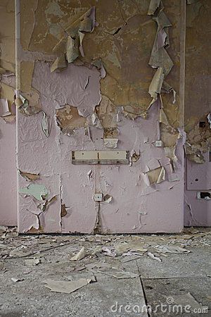 an old run down building with peeling paint on the walls and broken plaster all over it