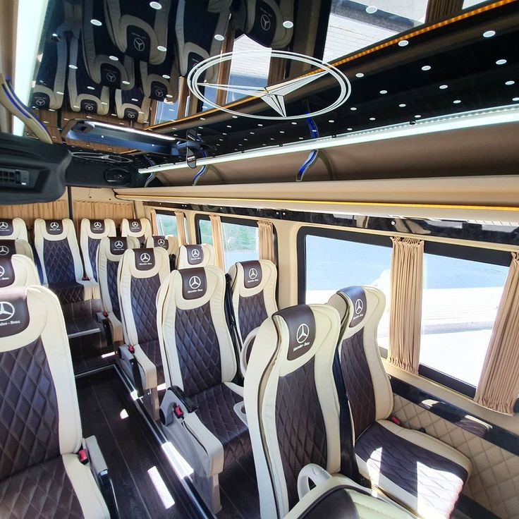 the interior of a bus with black and white seats