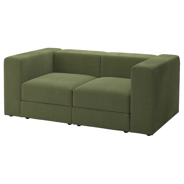 a green couch sitting on top of a white floor