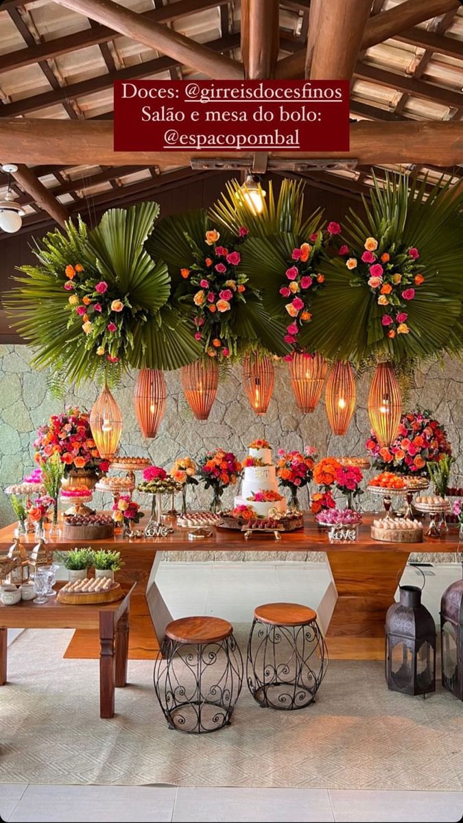 a table is set up with flowers, candles and vases on it for an event