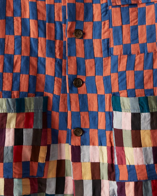 an orange and blue checkered jacket with buttons