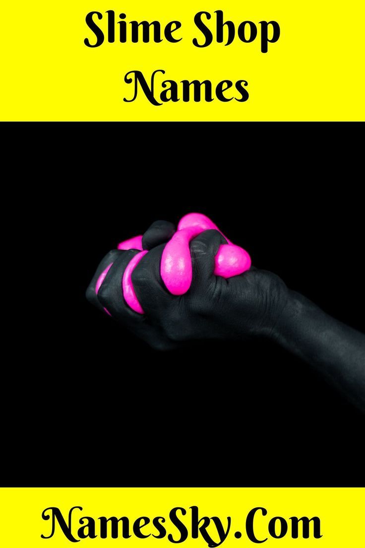 a hand with black and pink paint on it holding a neon pink object in the dark