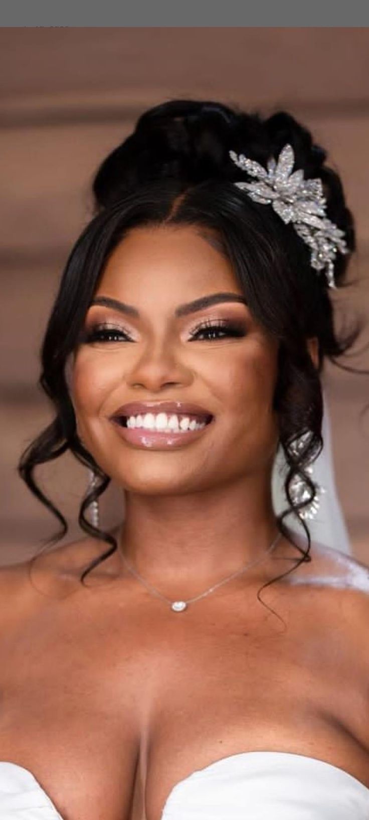 a woman in a wedding dress smiling at the camera