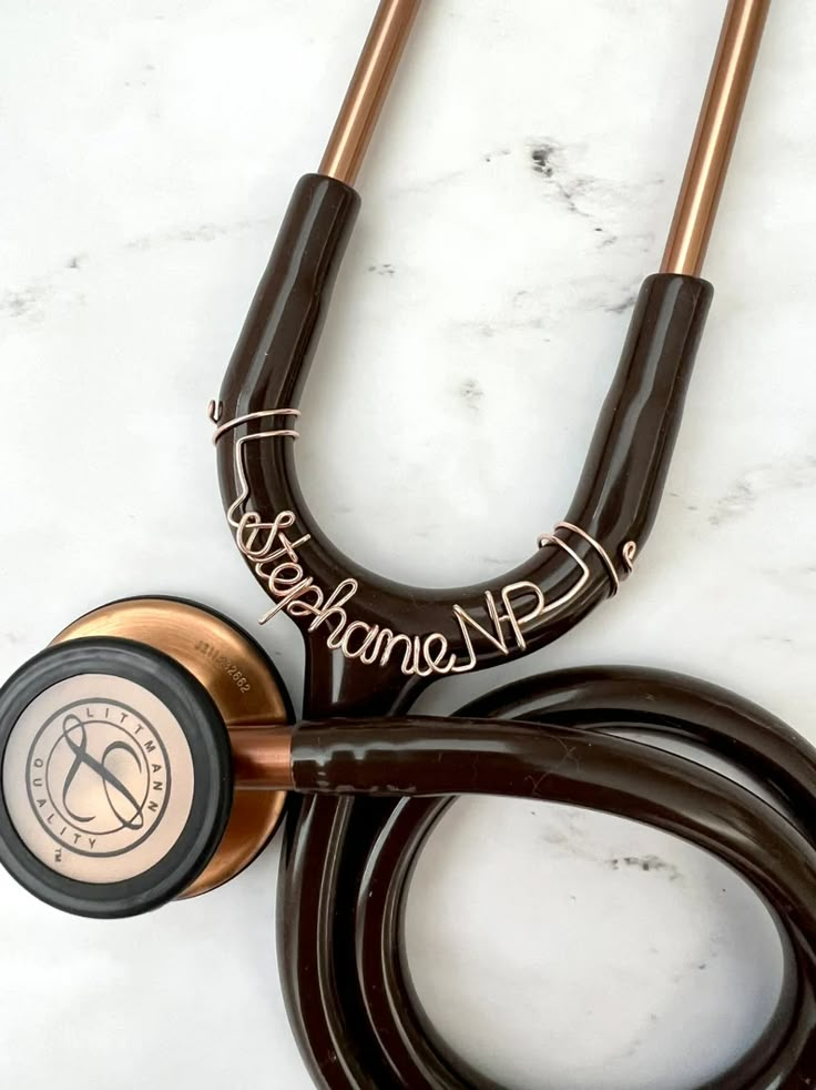 a stethoscope laying on top of a white counter next to a brown cord