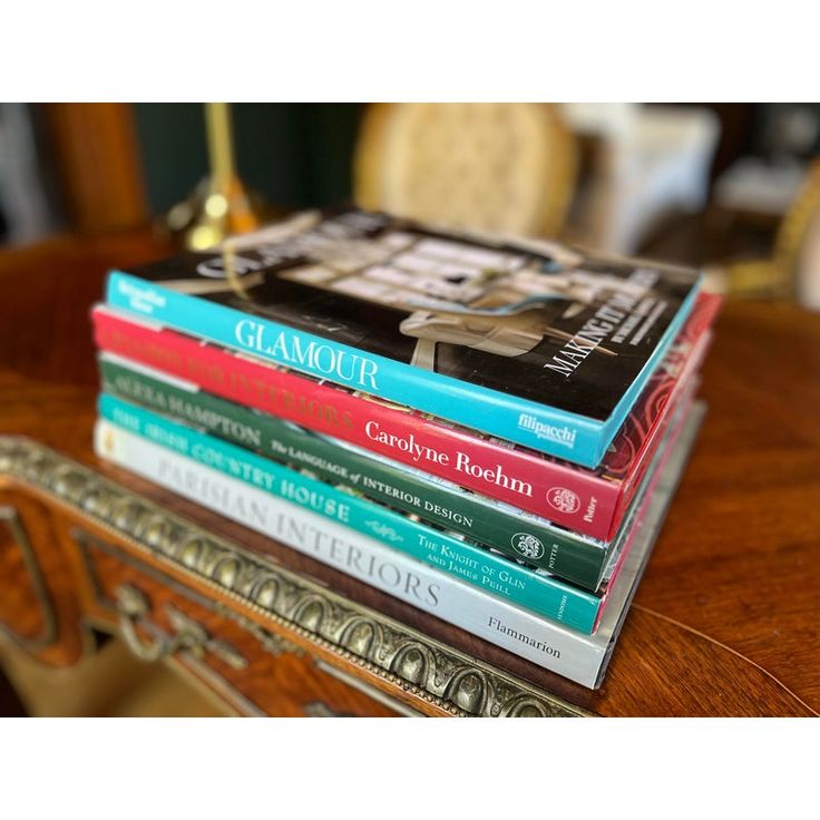 a stack of books sitting on top of a wooden table