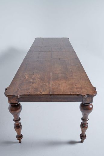 an old wooden table with turned legs