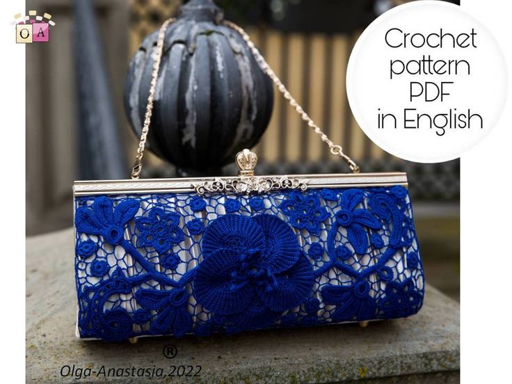 a blue lace clutch bag sitting on top of a stone bench next to a pumpkin