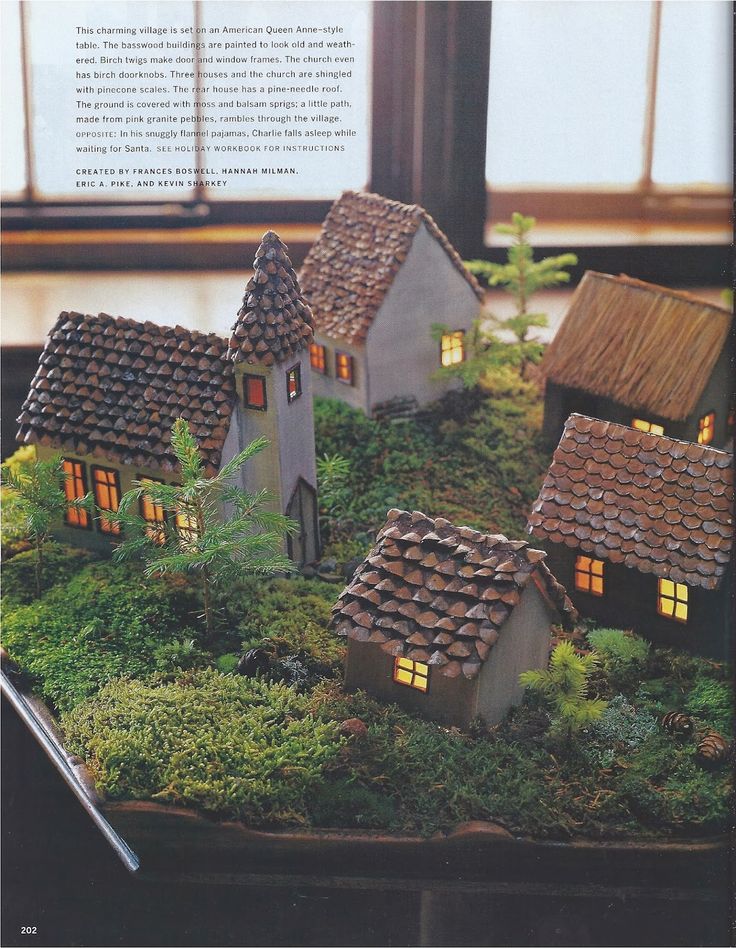 a model house with lights on and moss growing in the roof area next to it