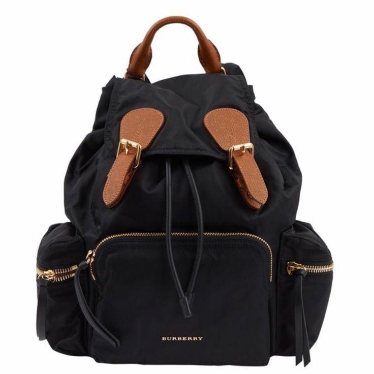 Burberry Prorsum Black Rucksack With Tan Textured Leather Details And Gold Tone Metal Hardware. A Handle, Adjustable Ribbons And Chain Shoulder Straps. Shoulder Straps 76cm, Handle Height 4cm. Luxury Leather Trim Backpack Shoulder Bag, Luxury Leather Trim Shoulder Backpack, Luxury Backpack With Removable Pouch For Errands, Designer Standard Backpack With Branded Hardware, Everyday Backpack With Branded Hardware, Designer Everyday Backpack With Removable Pouch, Luxury Backpack With Adjustable Strap For Errands, Standard Backpack With Branded Hardware For On-the-go, Burberry Backpack