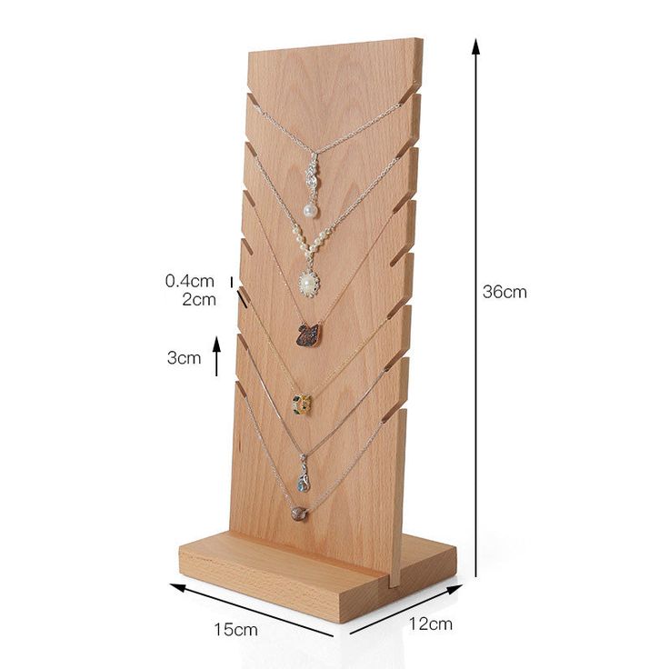 a wooden display case with multiple necklaces on it and measurements for each item in the image