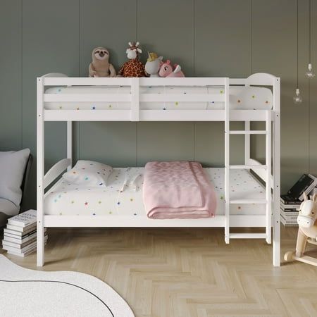 a white bunk bed sitting in a bedroom next to a stuffed animal on top of it