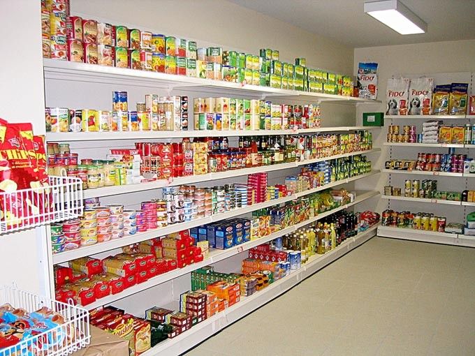 an aisle in a grocery store filled with lots of food and drink cans on the shelves