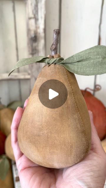 a person holding up a piece of fruit