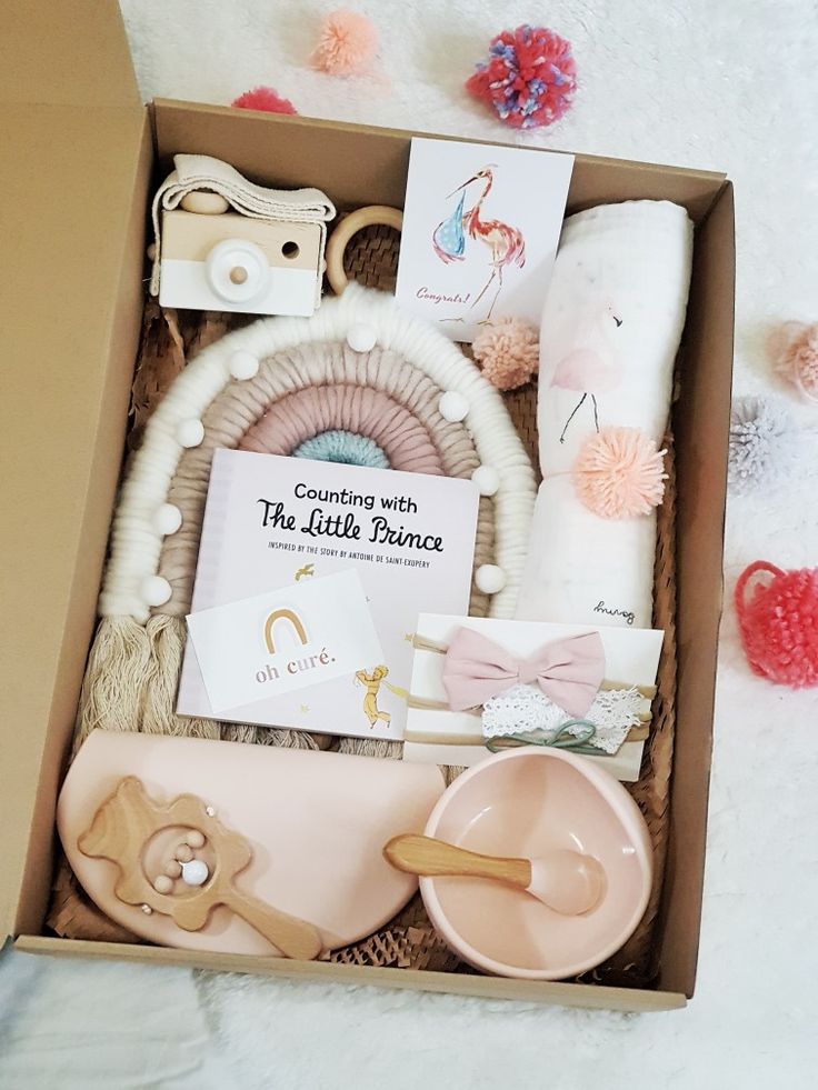 the little prince gift box is filled with toys and other things to give as a baby shower