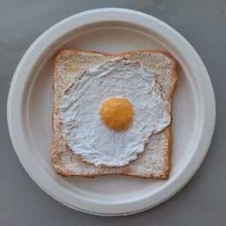 an egg is on top of a piece of bread