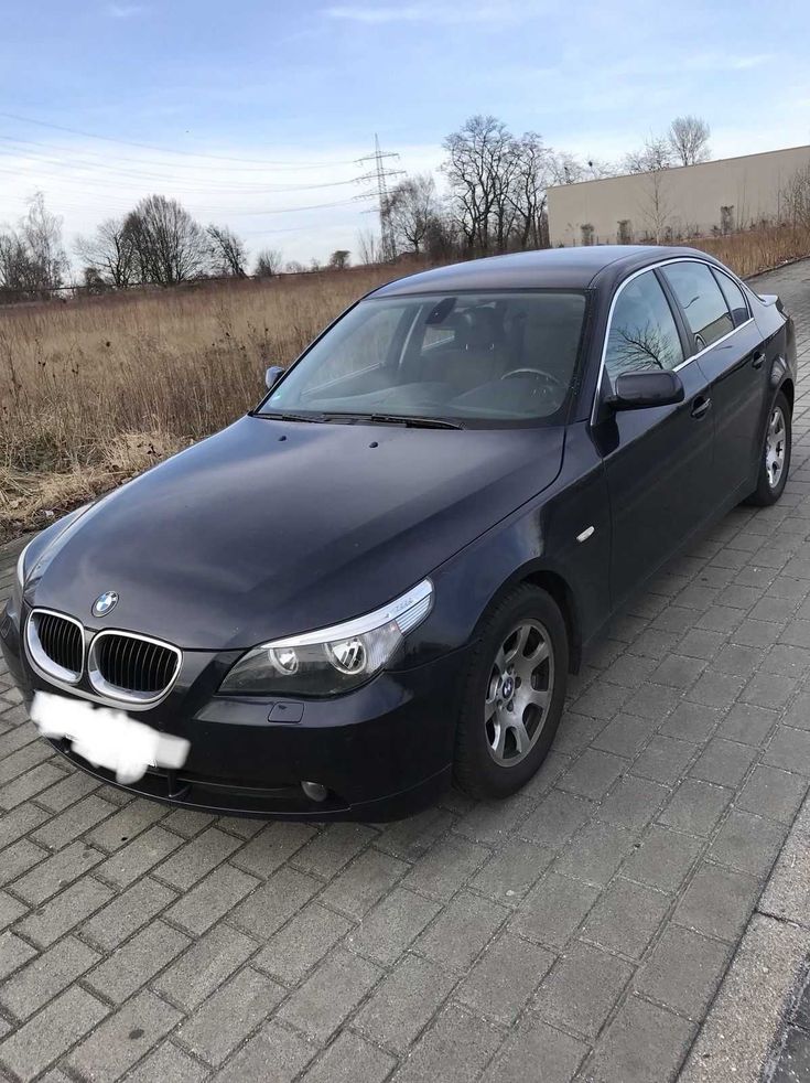 a black car is parked on the side of the road