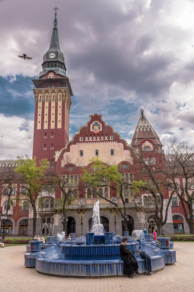 a large building with a fountain in front of it