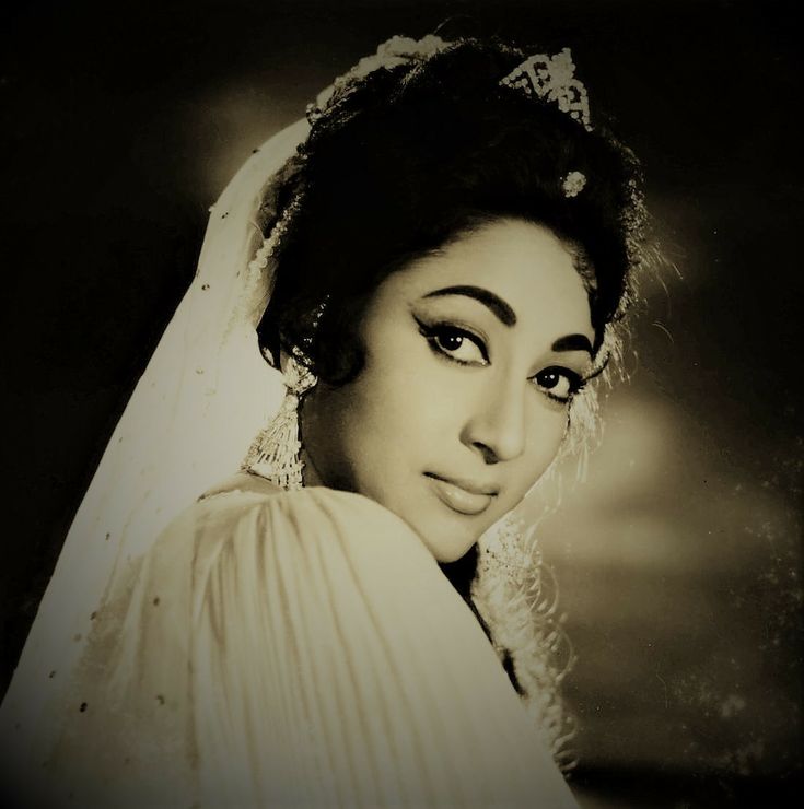 an old black and white photo of a woman wearing a wedding dress with veil on her head