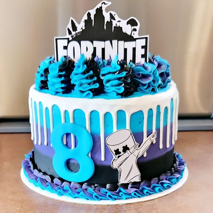 a birthday cake with blue frosting and an image of fortnite on top