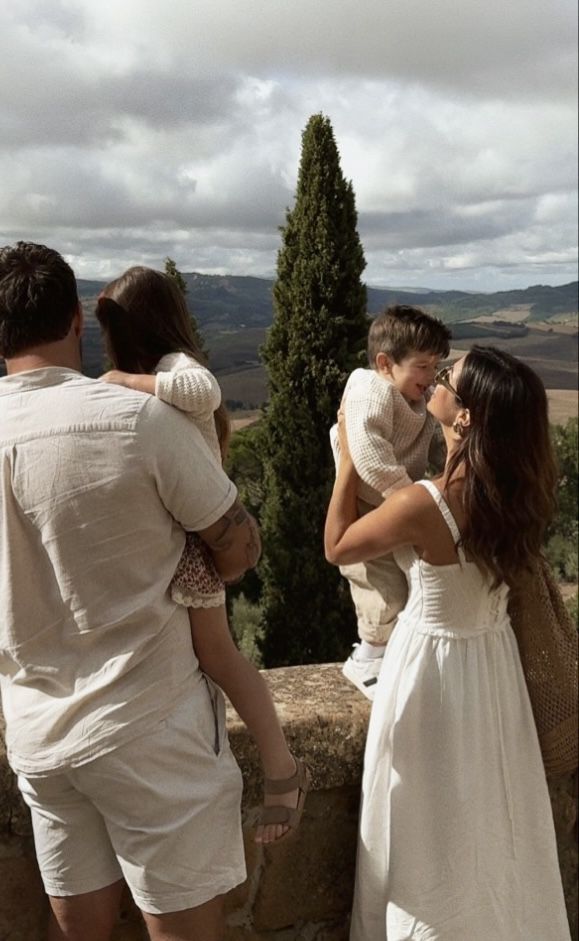 a group of people standing on top of a stone wall