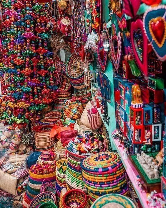 colorful baskets and necklaces for sale in a market