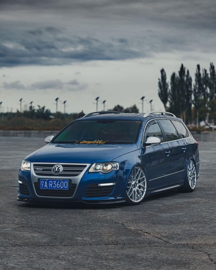 a blue car parked in an empty parking lot