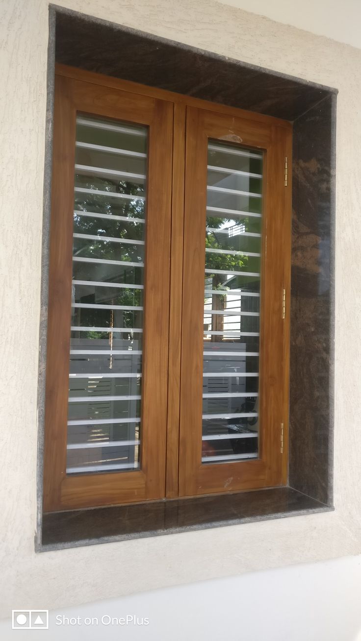 an open window with wooden shutters on the outside