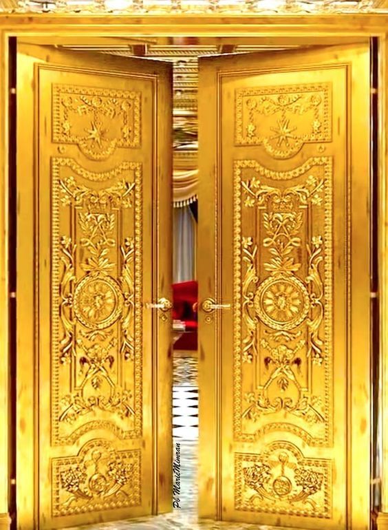 an open golden door with ornate designs on the front and side doors, in gold