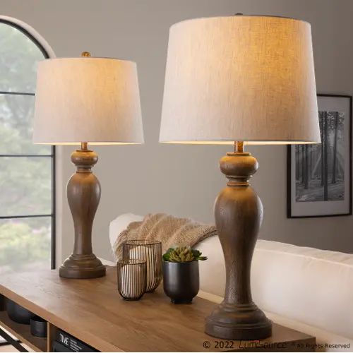 two lamps sitting on top of a wooden table