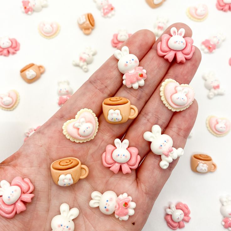 a hand is full of small decorated cookies