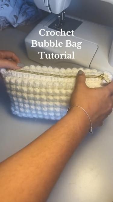 a woman is using a crochet bubble bag to sew on the sewing machine