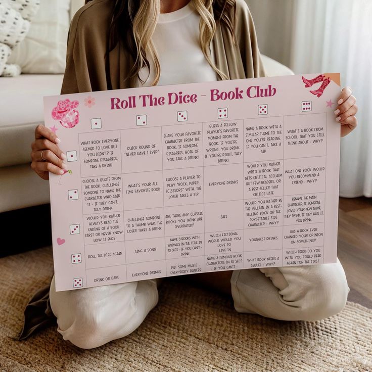 a woman sitting on the floor holding up a sign that says roll the dice book club