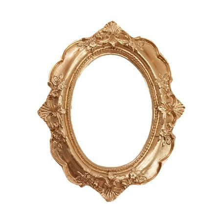 an ornate gold frame with flowers on the edges and a small round hole in the middle