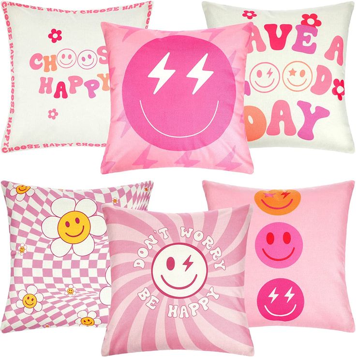 four pillows with different designs on them, one has a smiley face and the other has a