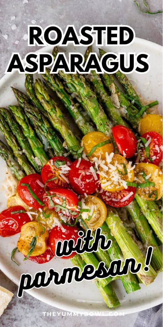 roasted asparagus with parmesan cheese and tomatoes on a white platter