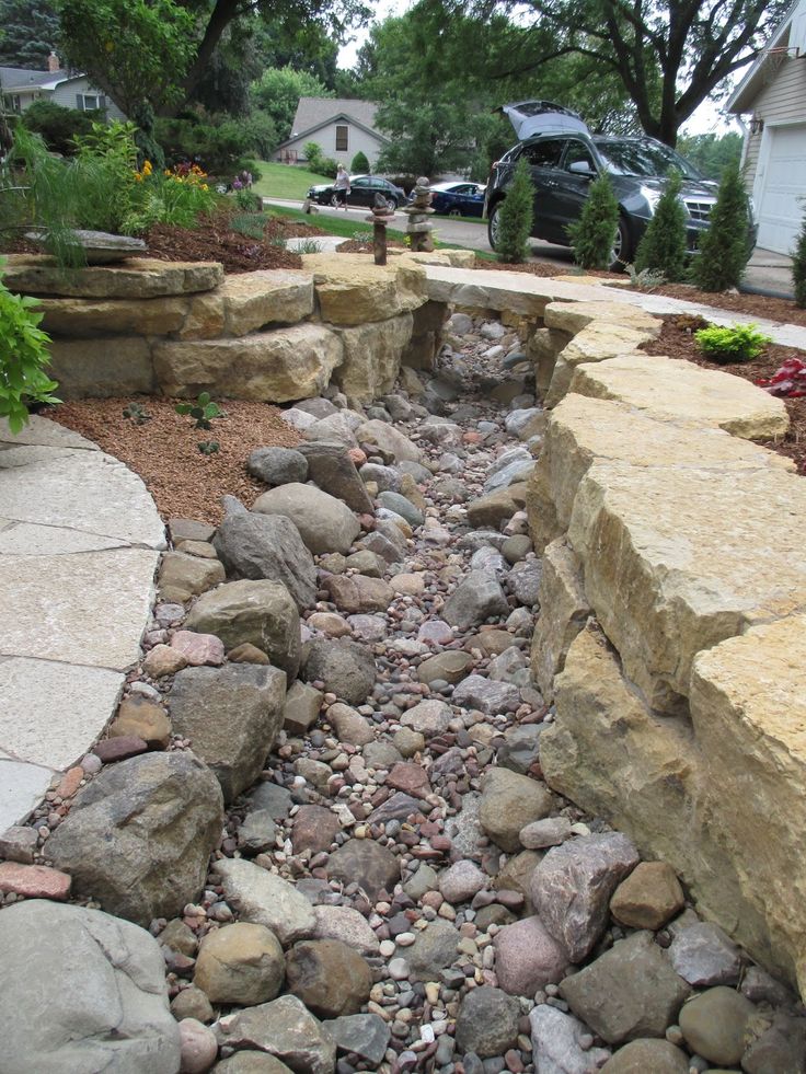 a garden with rocks and gravel in the middle