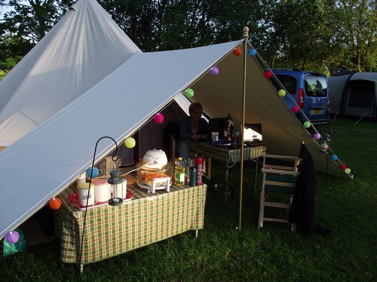 a tent with food and drinks on it in the grass