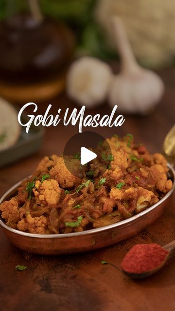 gobi masala in a metal bowl on a wooden table