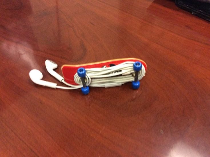 a red skateboard sitting on top of a wooden table