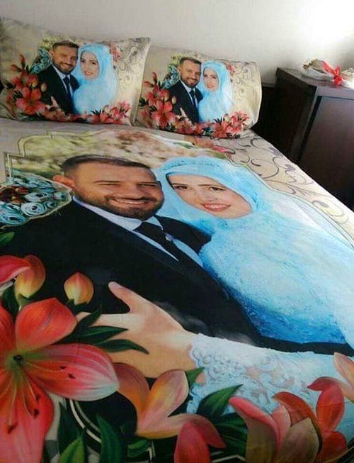 a bed covered in a couple's wedding photo on the comforter and pillows