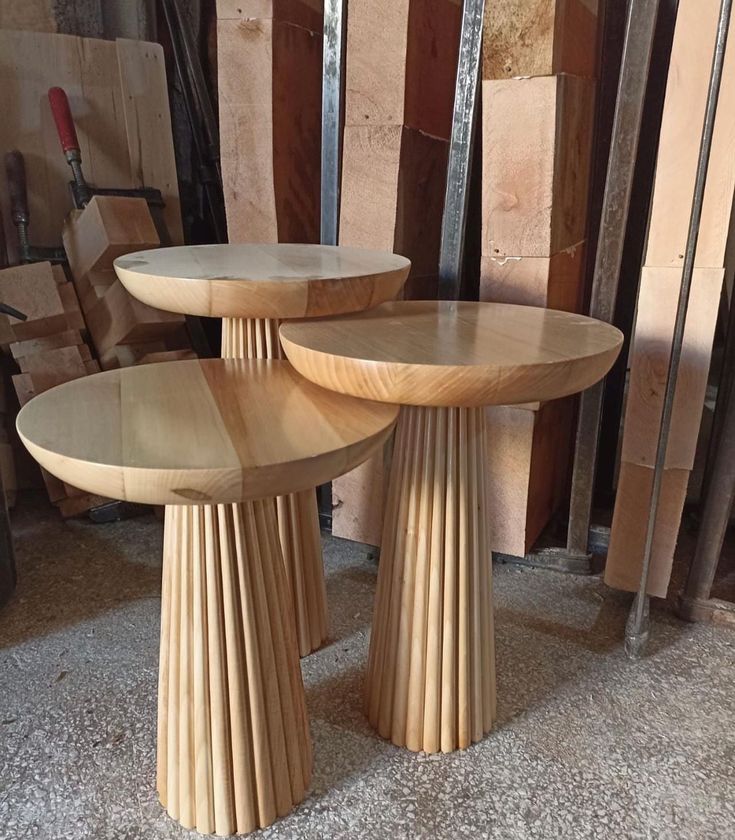 three wooden tables sitting on top of a floor